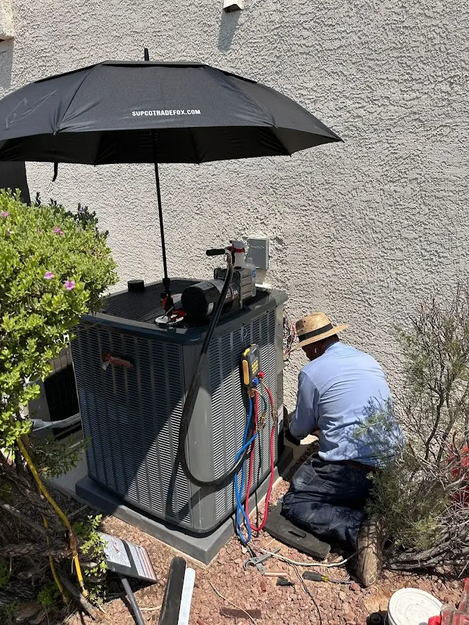 HVAC technician performing outdoor AC maintenance in Sun City Center